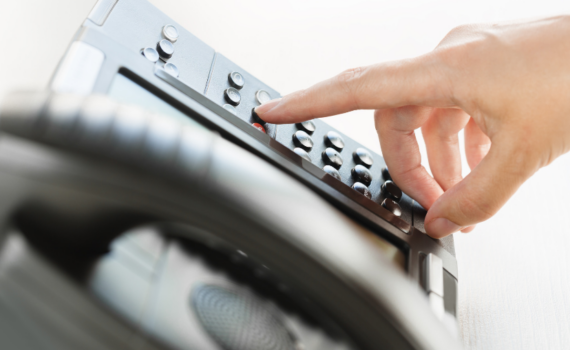 close up of work telephone to show three signs that your business needs a VoIP system