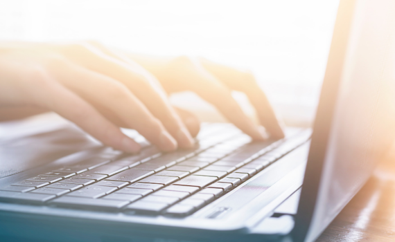 A woman researching on her laptop the best options for upgrading from Microsoft Office twenty thirteen for her small business