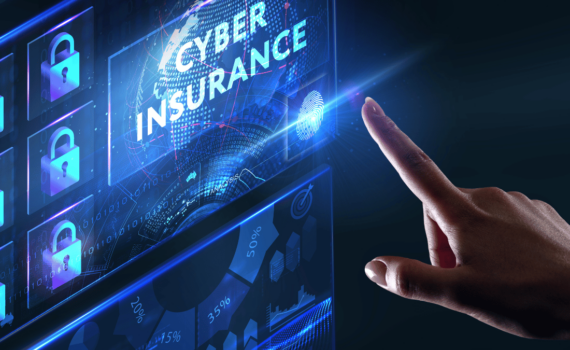 An SME business owner using a finger scanner on their desktop screen to install cyber insurance, ensuring their business is protected against cybercrime