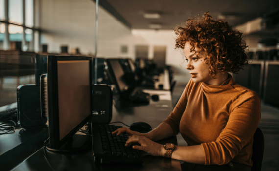A woman providing IT support to a business after Microsoft decided to end support for Windows 10.