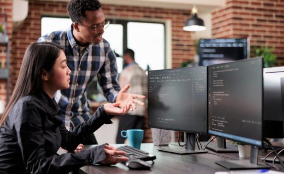 Employees learning how how regular cyber security reviews protect your business from emerging threats.